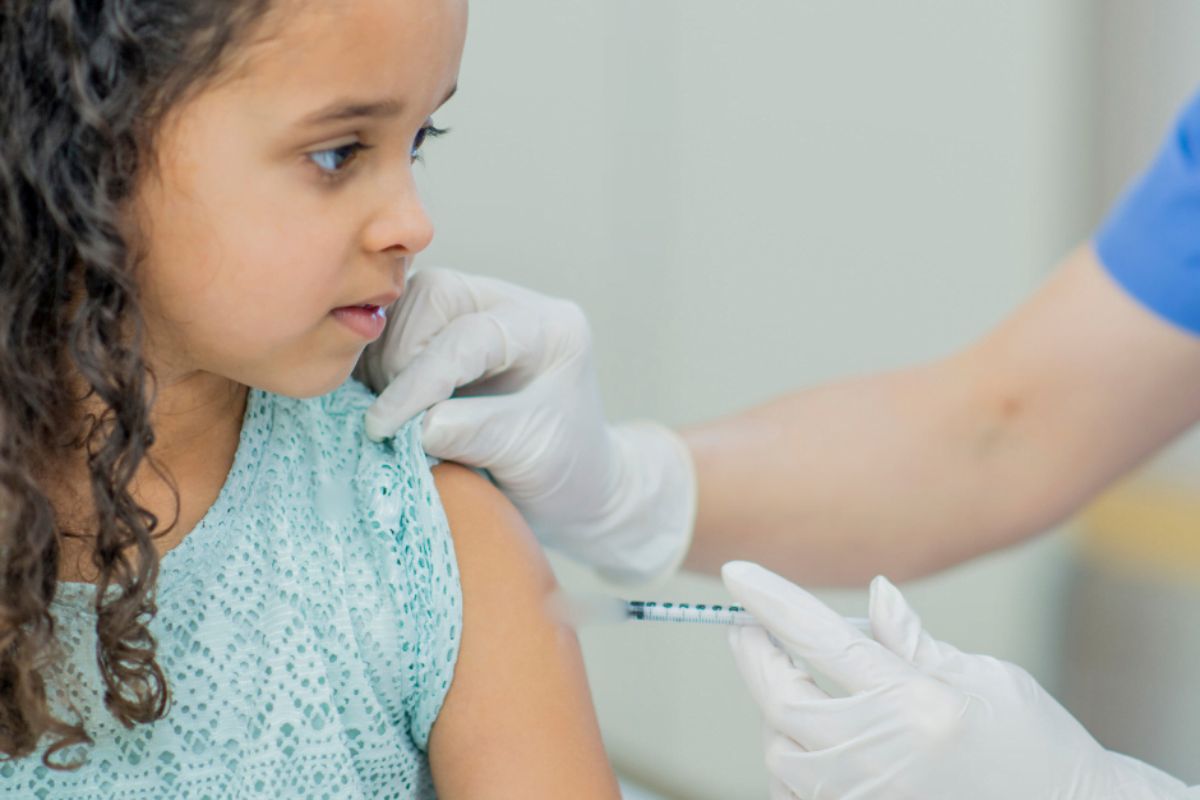 Child in medical clinic for an injection.